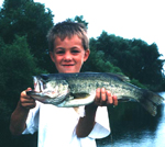 Proud young angler with bass catch. Click for larger image.